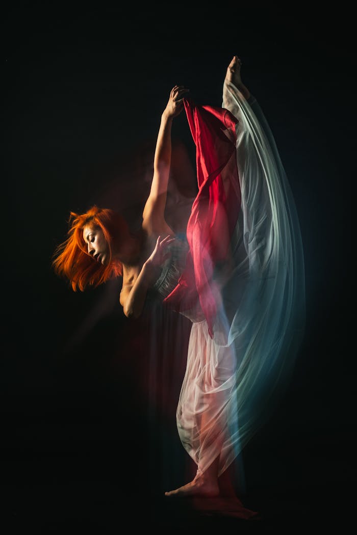 Artistic portrayal of a dancer in motion using long exposure effect.
