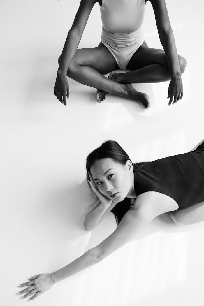 A grayscale artistic portrayal of two women in dance poses.